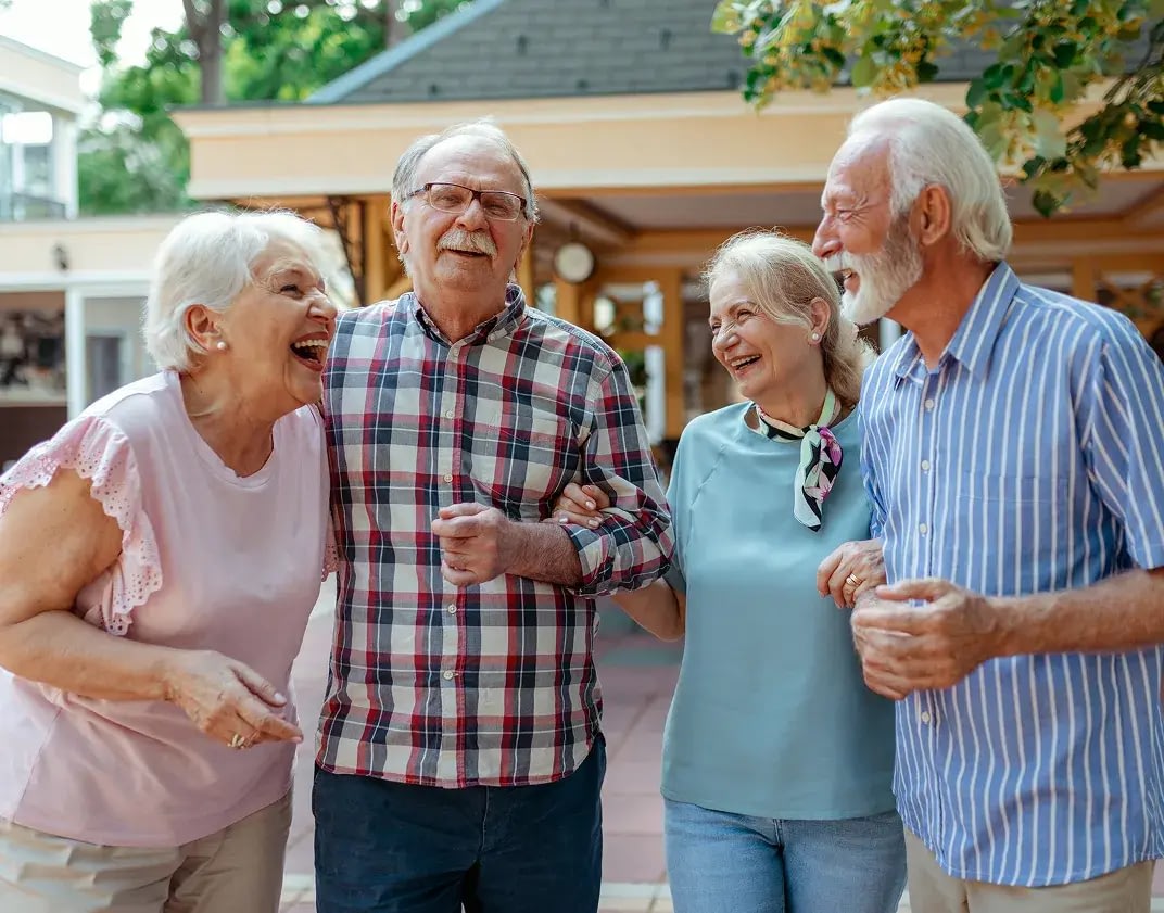 Happy seniors laughing outdoors together