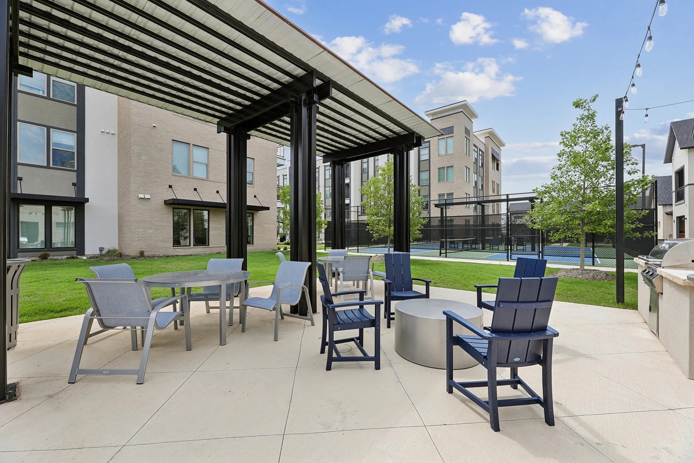 Outdoor patio with seating near apartment buildings