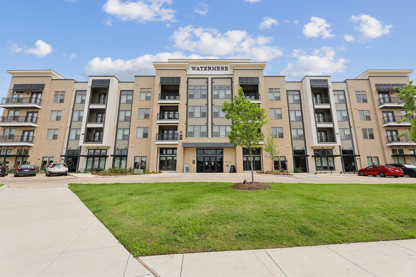 Modern apartment building with green lawn