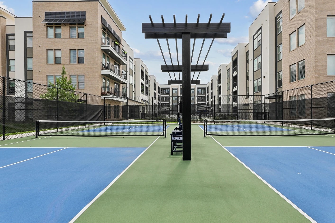 Modern apartment complex with outdoor tennis courts