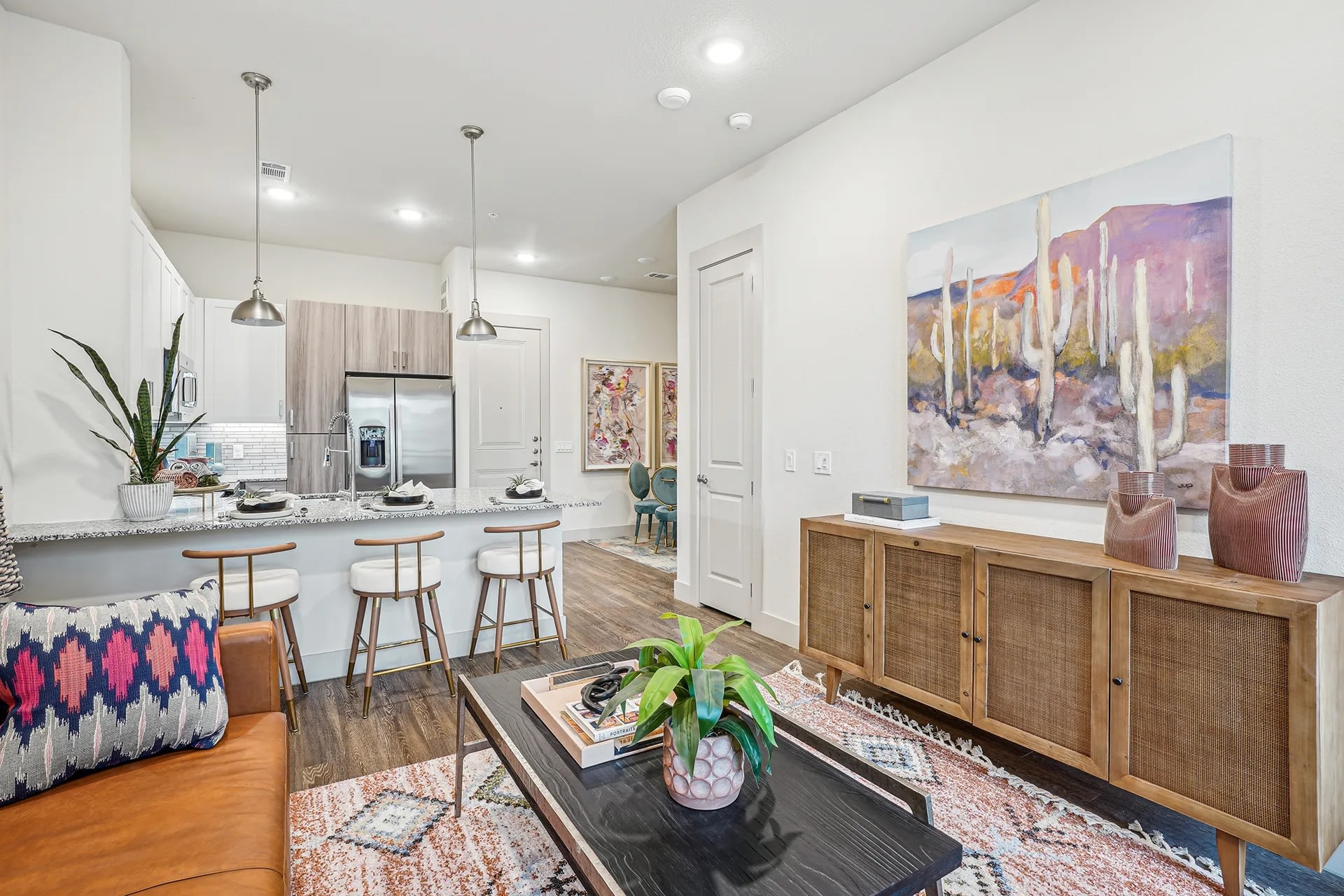 Bright open layout connecting the kitchen and living room in a modern apartment.