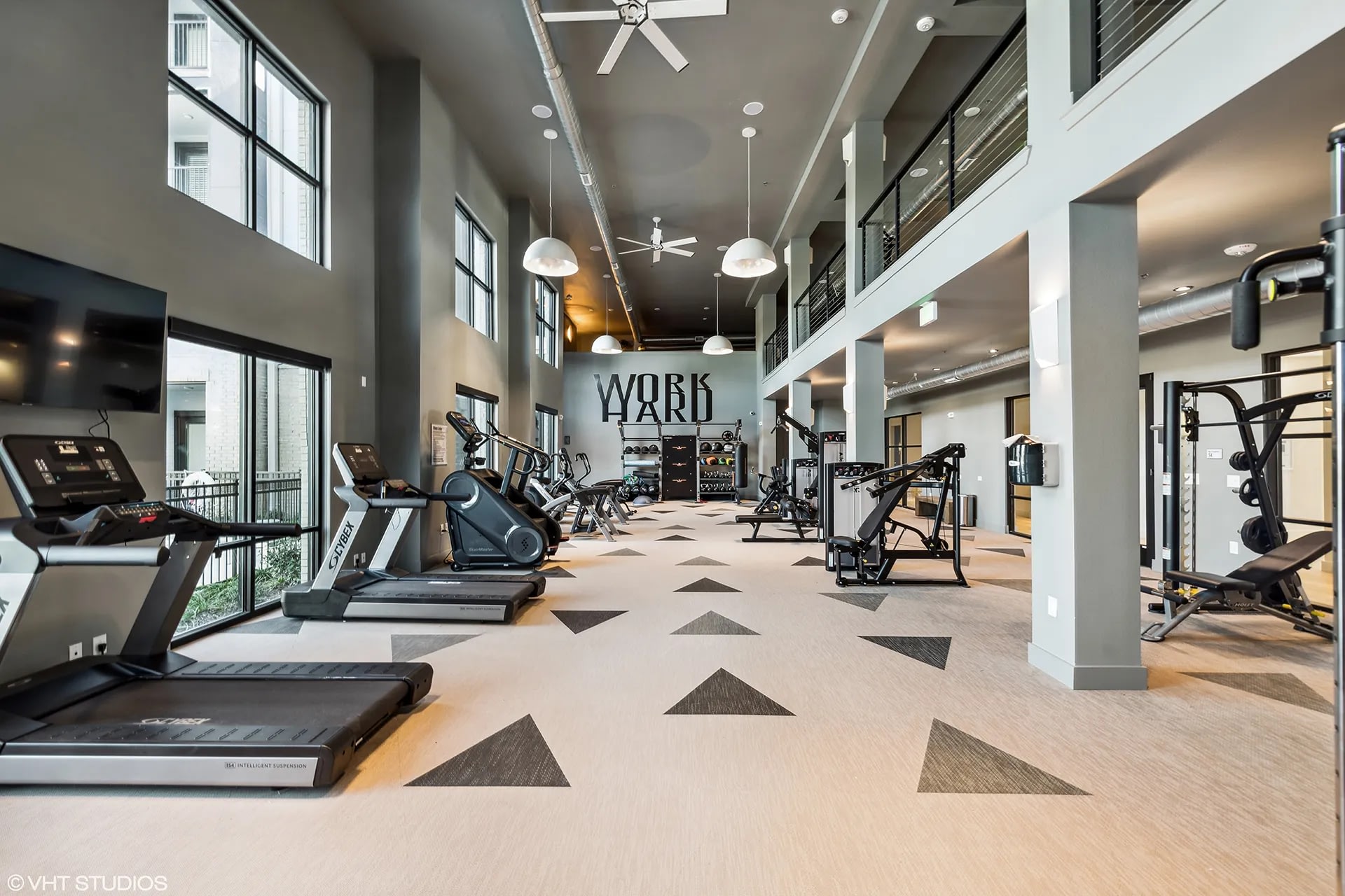Modern fitness center featuring cardio machines and weight equipment.