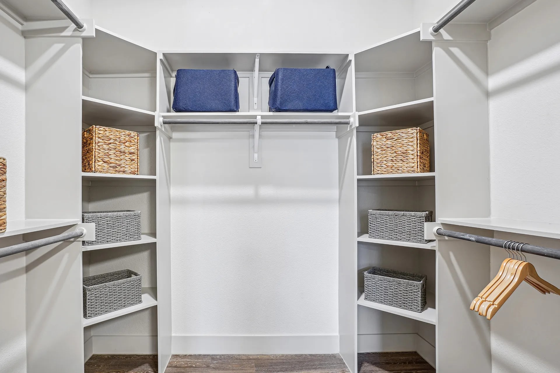 Spacious walk-in closet with built-in shelving and hanging space.