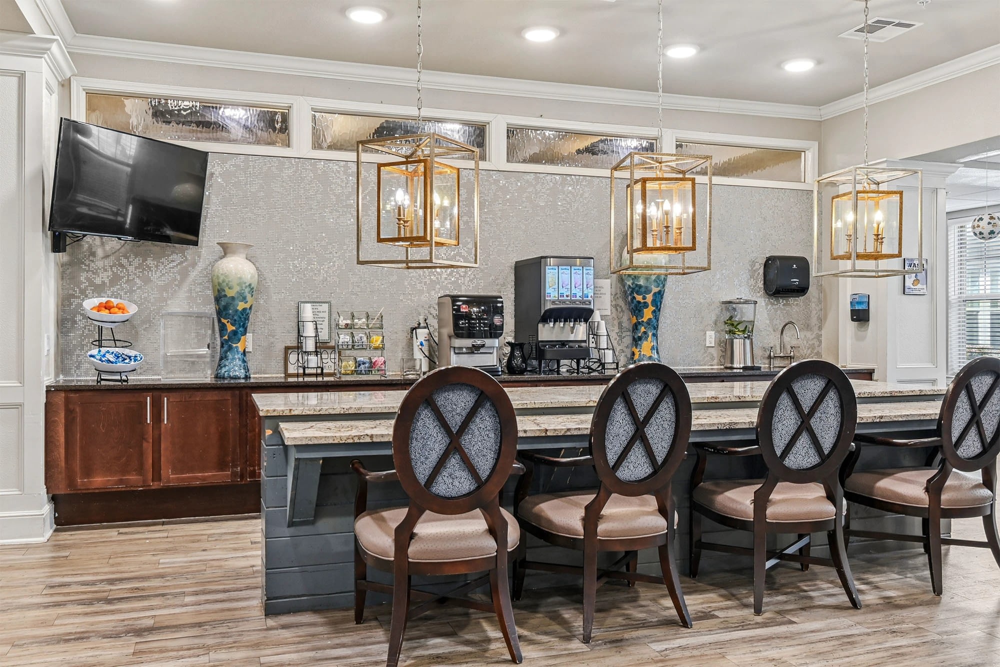 Modern coffee bar with seating and chandeliers