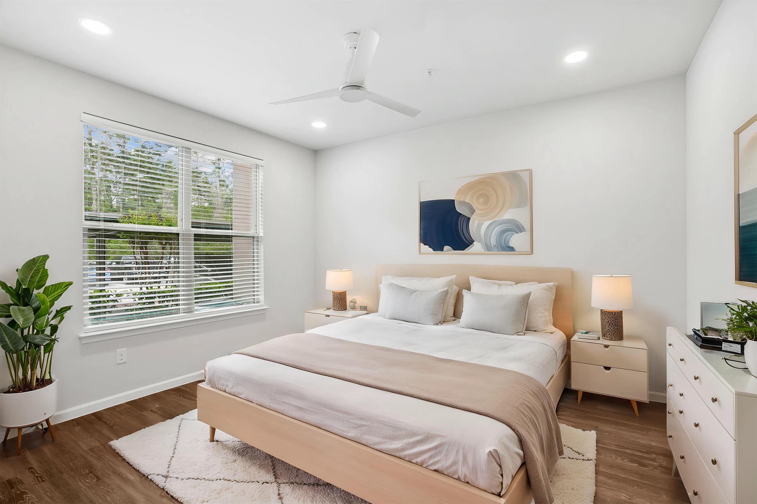Modern bedroom with large window and cozy decor