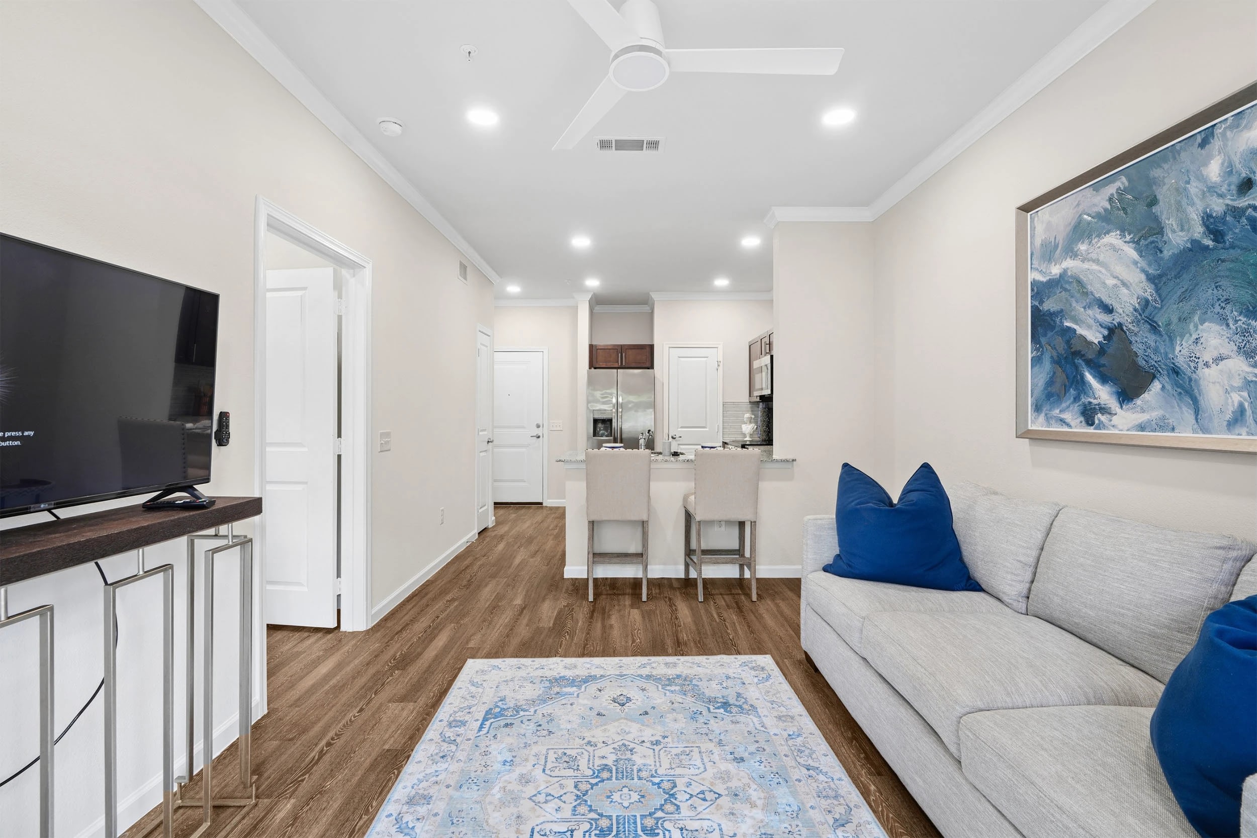 Modern living room with kitchen and blue decor