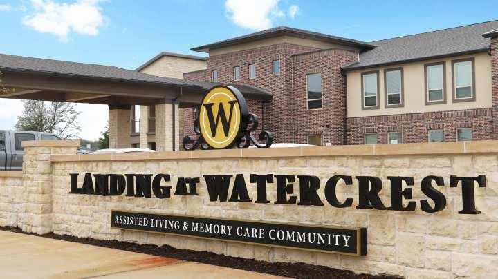 Residents sitting around tables in dining room enjoying meals together