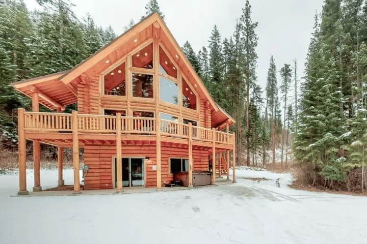 Wooden cabin in snowy forest winter landscape
